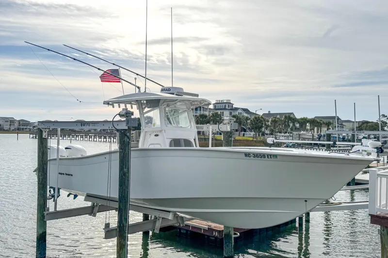  Yacht Photos Pics 2021 Cape Horn 31 T boat docked with fishing rods and American flag.