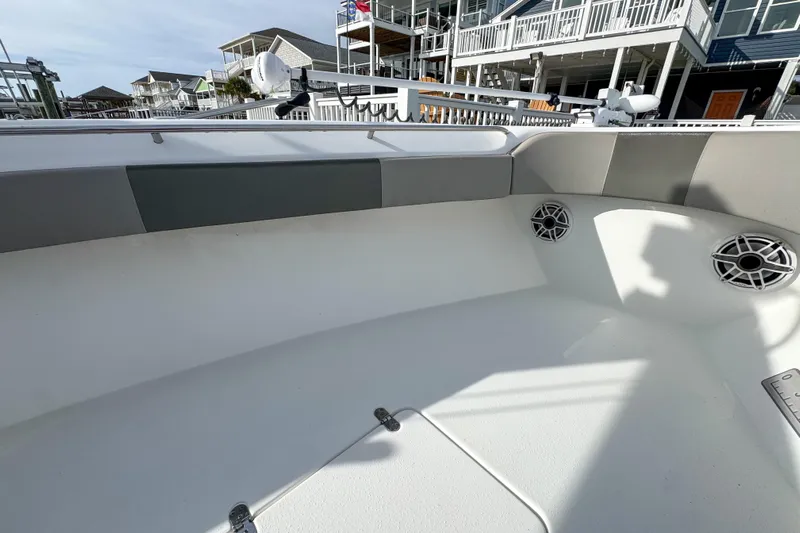  Yacht Photos Pics 2021 Cape Horn 31 T boat interior with speakers and seating, docked near waterfront homes.