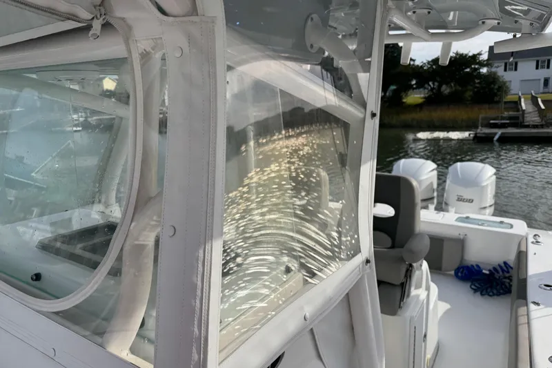  Yacht Photos Pics 2021 Cape Horn 31 T boat with dual engines, docked near waterfront homes.