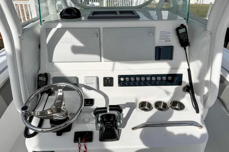  Yacht Photos Pics 2021 Cape Horn 31 T boat console with steering wheel, controls, and Simrad electronics.