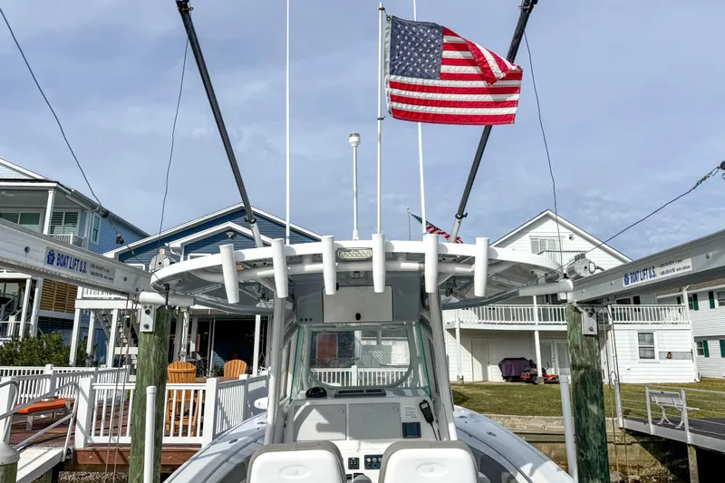  Yacht Photos Pics 2021 Cape Horn 31 T boat docked with American flag, residential background.