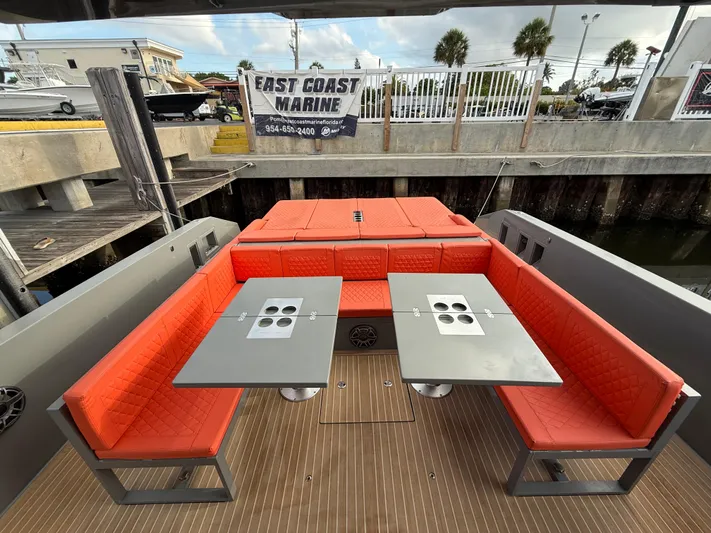  Yacht Photos Pics 2021 De Antonio Yachts D42 with red seating and dual tables, docked at East Coast Marine.