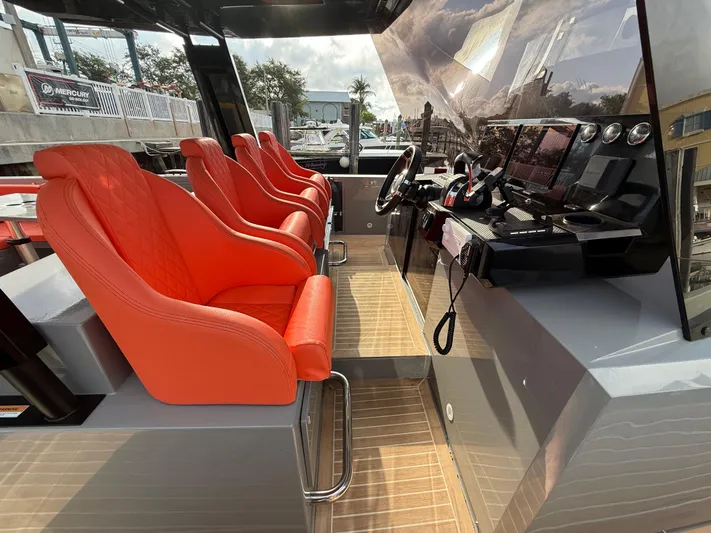  Yacht Photos Pics Interior of 2021 De Antonio Yachts D42 with red seats and modern dashboard.