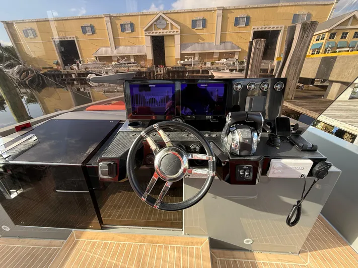  Yacht Photos Pics Helm of 2021 De Antonio Yachts D42 with modern controls and waterfront view.