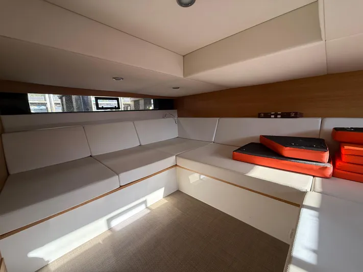  Yacht Photos Pics Interior of 2021 De Antonio Yachts D42, featuring modern seating and cushions.