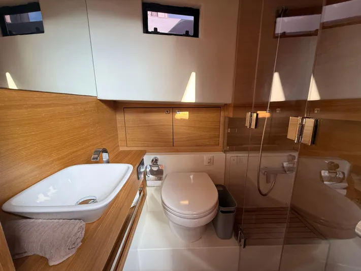  Yacht Photos Pics Luxurious bathroom in 2021 De Antonio Yachts D42, featuring modern fixtures and wooden accents.