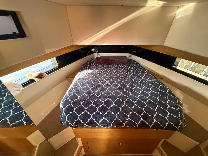 Yacht Photos Pics Cozy cabin interior of 2021 De Antonio Yachts D42 with patterned bedding.