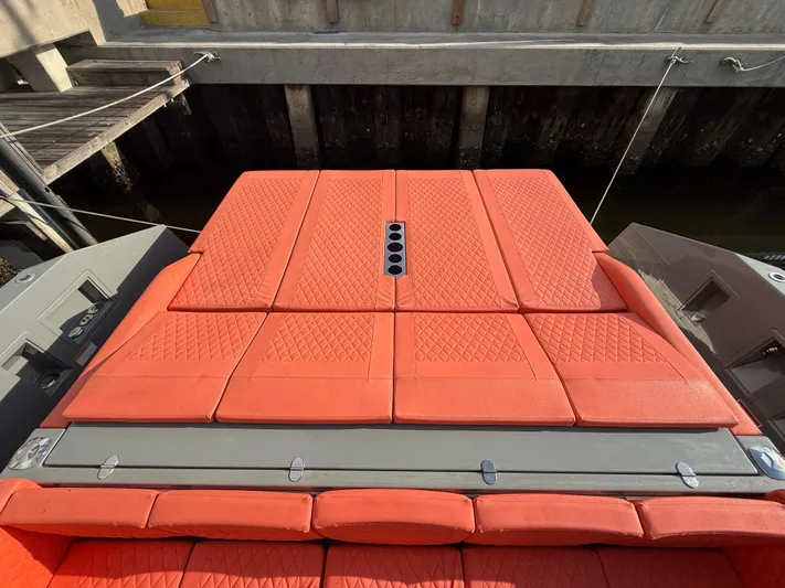  Yacht Photos Pics Red cushioned deck of 2021 De Antonio Yachts D42, docked at a marina.