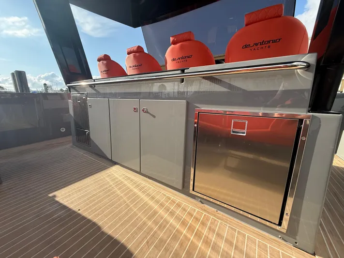  Yacht Photos Pics 2021 De Antonio Yachts D42 deck with sleek cabinetry and vibrant red seating.