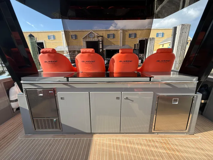  Yacht Photos Pics 2021 De Antonio Yachts D42 with red seats and sleek outdoor kitchen setup.