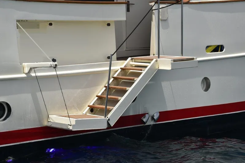  Yacht Photos Pics Staircase on 2005 Explorer Classic 34m yacht, docked with visible hull details.