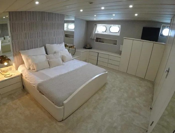  Yacht Photos Pics Luxurious bedroom interior on 2005 Explorer Classic 34m yacht, featuring elegant decor and ample storage.