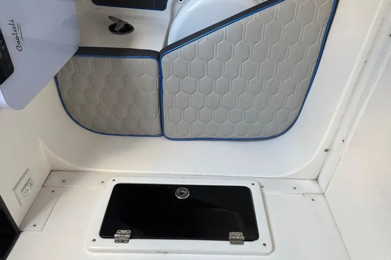  Yacht Photos Pics 2024 GSX 36 interior with hexagonal-patterned upholstery and storage compartment.