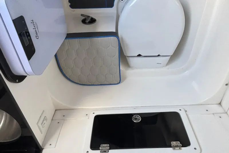  Yacht Photos Pics 2024 GSX 36 interior with compact toilet and storage compartment.