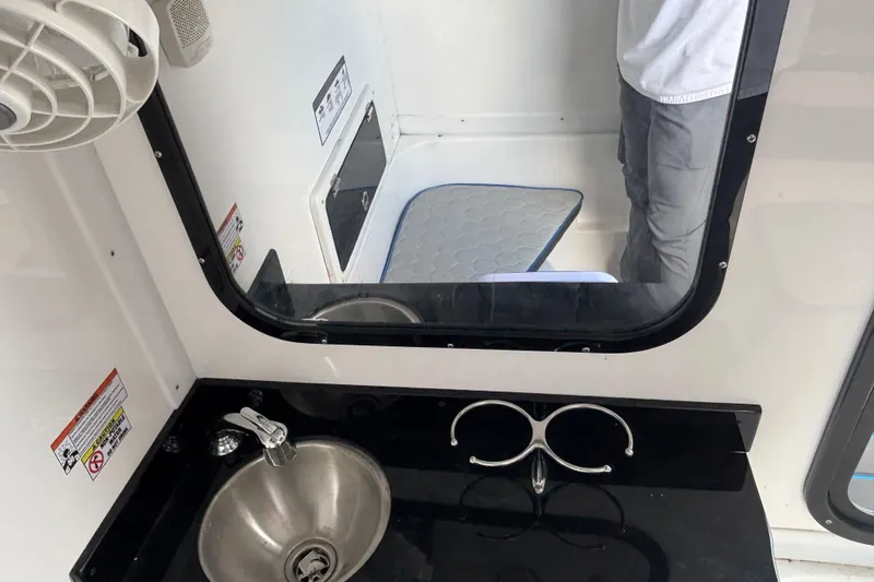  Yacht Photos Pics 2024 GSX 36 interior with sink, mirror, and storage compartment.