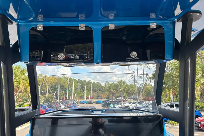  Yacht Photos Pics 2024 GSX 36 boat interior with blue overhead compartments and scenic outdoor view.