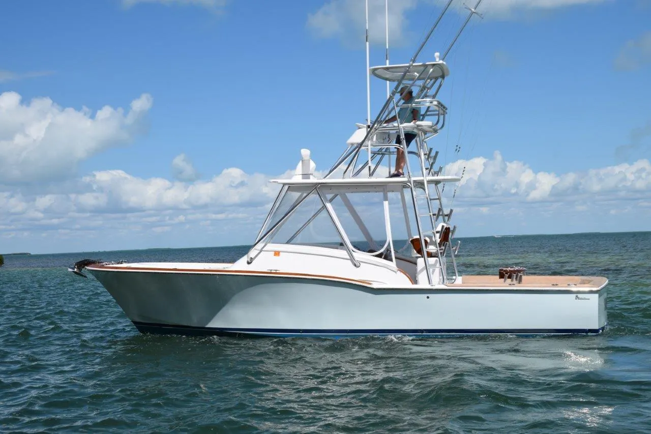 2024 L&H Walk-Around Sportfish boat on open water under blue sky.
