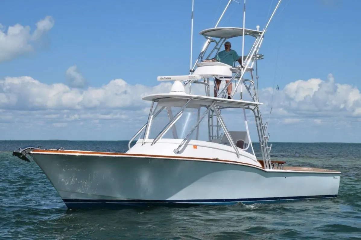2024 L&H Walk-Around Sportfish boat on the water with a person on the upper deck.