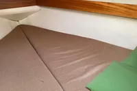 Cozy cabin interior of 1998 ACM Heritage 26 boat with brown bedding.