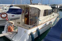1998 ACM Heritage 26 boat docked in a marina, surrounded by other vessels.