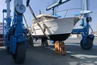 ACM Heritage 26 boat from 1998 on a lift at a marina.