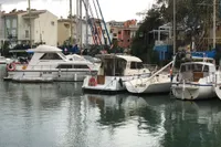Boats docked in a marina, featuring a 1998 ACM Heritage 26.