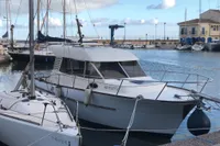 1998 ACM Heritage 26 boat docked in a marina with other sailboats.