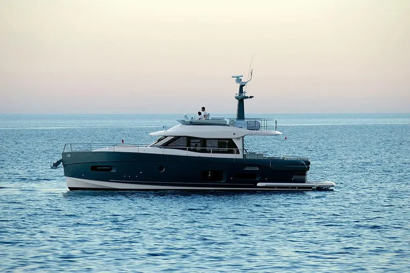  Yacht Photos Pics 2015 Azimut Magellano 53 yacht cruising on calm ocean waters at sunset.