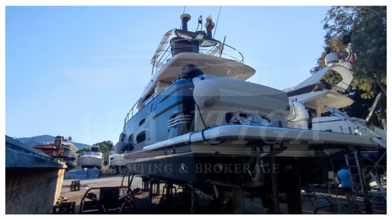  Yacht Photos Pics Azimut Magellano 53 yacht, 2015 model, docked in a marina with clear blue sky.