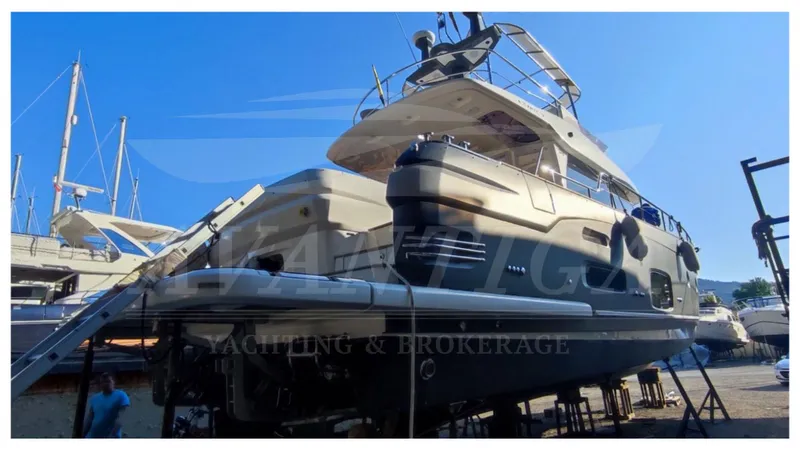  Yacht Photos Pics Azimut Magellano 53 yacht, 2015 model, docked for maintenance under clear blue sky.