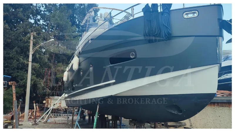  Yacht Photos Pics 2015 Azimut Magellano 53 yacht on dry dock, side view with trees in background.