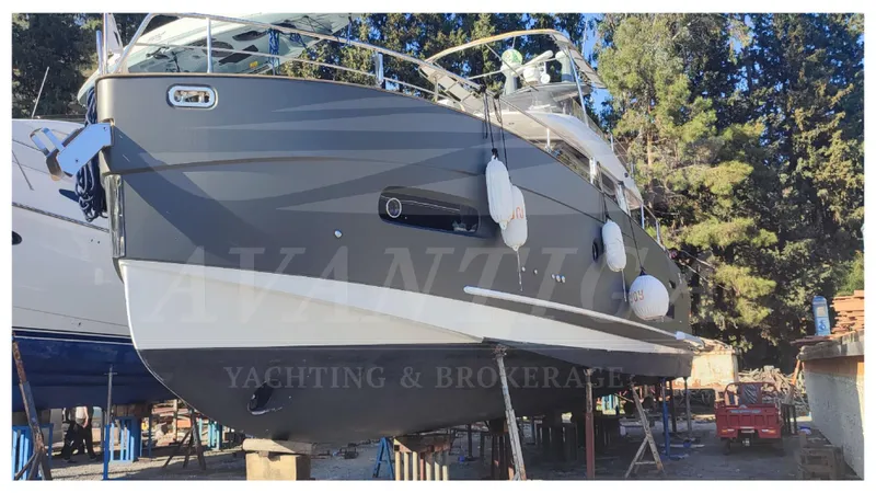  Yacht Photos Pics 2015 Azimut Magellano 53 yacht on dry dock, side view with trees in background.