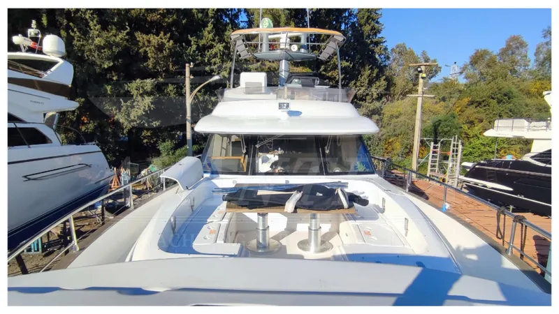  Yacht Photos Pics Azimut Magellano 53 yacht, 2015 model, docked with trees in the background.