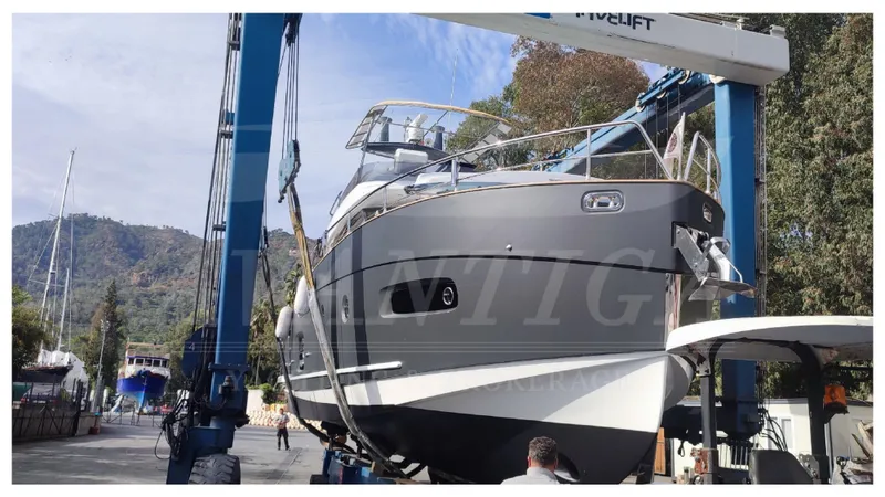  Yacht Photos Pics 2015 Azimut Magellano 53 yacht in dry dock, lifted by crane for maintenance.