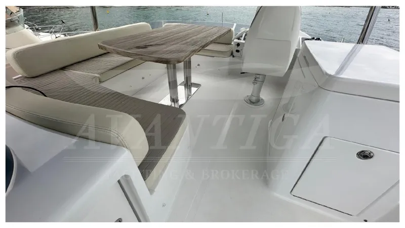  Yacht Photos Pics Luxurious seating area on 2015 Azimut Magellano 53 yacht with wooden table.