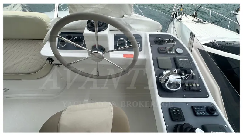  Yacht Photos Pics Cockpit of 2015 Azimut Magellano 53 yacht with steering wheel and control panel.
