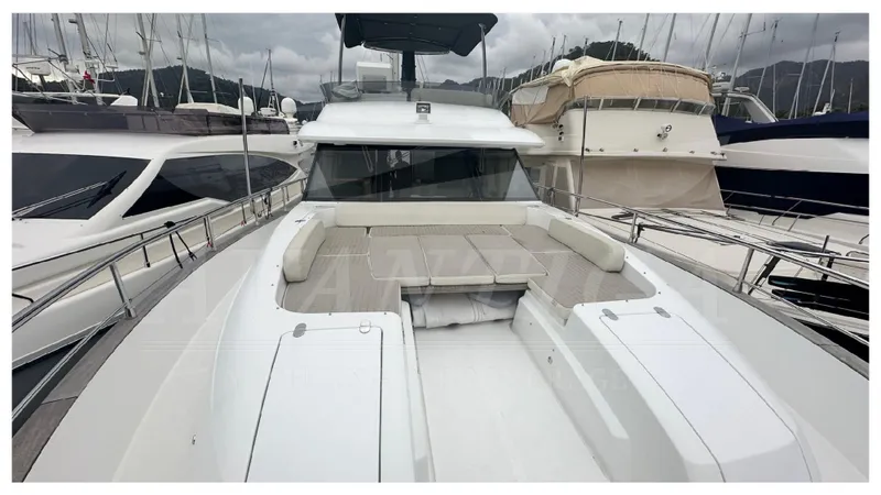  Yacht Photos Pics 2015 Azimut Magellano 53 yacht with spacious deck and seating area, docked at marina.
