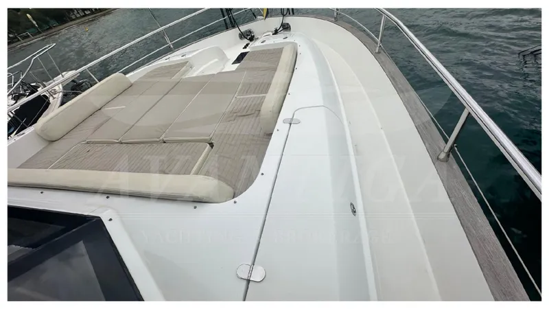  Yacht Photos Pics 2015 Azimut Magellano 53 yacht deck with cushioned seating, docked by the water.