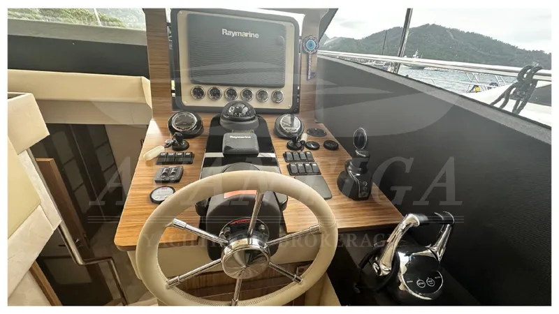  Yacht Photos Pics Cockpit of 2015 Azimut Magellano 53 yacht with steering wheel and navigation controls.