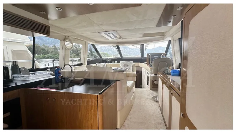  Yacht Photos Pics Luxurious interior of 2015 Azimut Magellano 53 yacht with modern furnishings and panoramic windows.