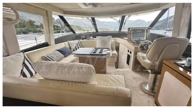  Yacht Photos Pics Luxurious interior of 2015 Azimut Magellano 53 yacht with plush seating and navigation controls.