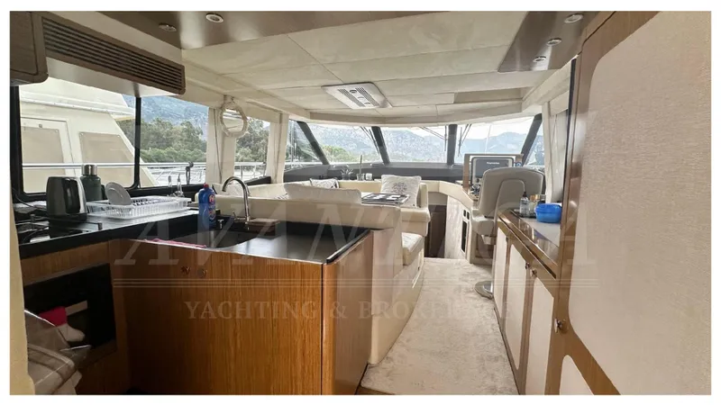  Yacht Photos Pics Luxurious interior of 2015 Azimut Magellano 53 yacht with modern furnishings and panoramic windows.