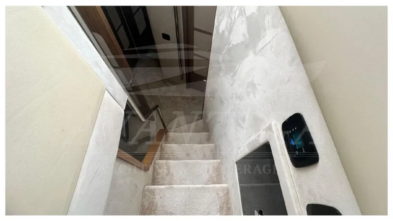  Yacht Photos Pics Staircase inside 2015 Azimut Magellano 53 yacht, featuring plush carpeting and modern design.