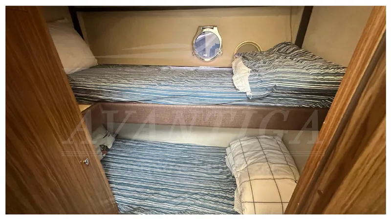  Yacht Photos Pics Bunk beds in 2015 Azimut Magellano 53 yacht cabin with striped bedding.