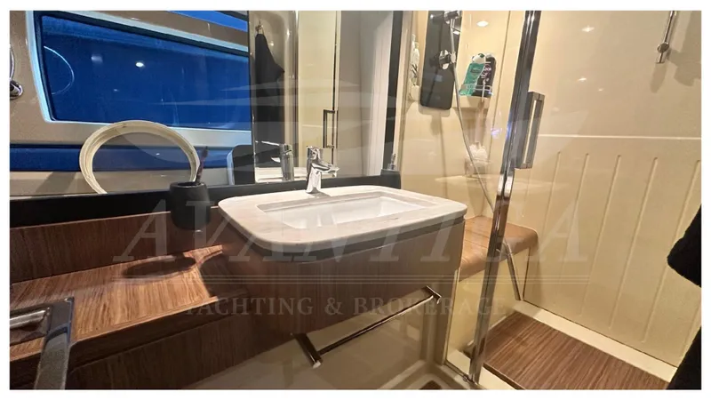  Yacht Photos Pics Bathroom interior of 2015 Azimut Magellano 53 yacht with modern sink and wooden accents.