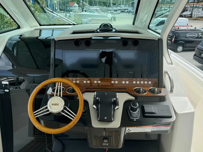  Yacht Photos Pics Helm of 2025 Tiara Yachts 34 LS with modern controls and wooden steering wheel.