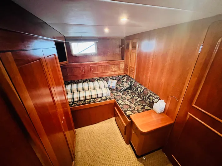 Journey Yacht Photos Pics Cozy cabin interior of 2001 Bracewell Latitude 47 yacht with wood paneling and bed.