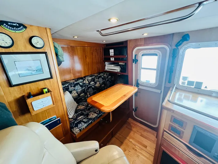 Journey Yacht Photos Pics Cozy interior of 2001 Bracewell Latitude 47 yacht with wooden furnishings and seating area.