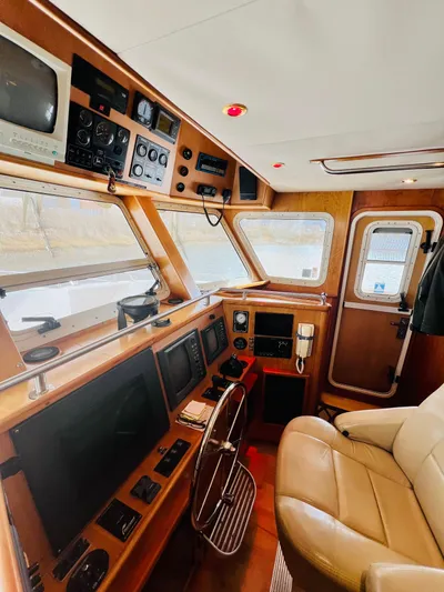 Journey Yacht Photos Pics Interior of 2001 Bracewell Latitude 47 yacht, featuring navigation controls and leather seating.