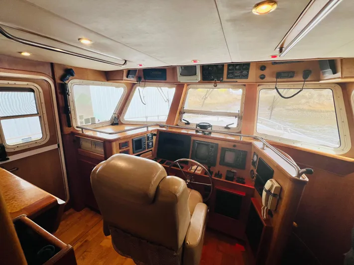Journey Yacht Photos Pics Pilothouse interior of 2001 Bracewell Latitude 47 yacht, featuring navigation equipment and captain's chair.
